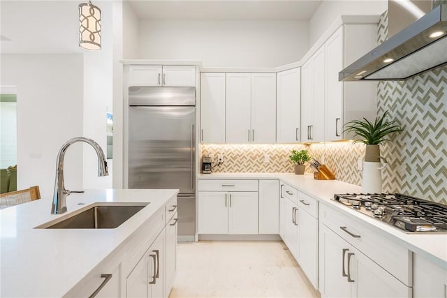 30 Strand Dr, Vero Beach, FL 32963 - kitchen featuring wall chimney exhaust hood, stainless steel appliances, white cabinetry, and light countertops