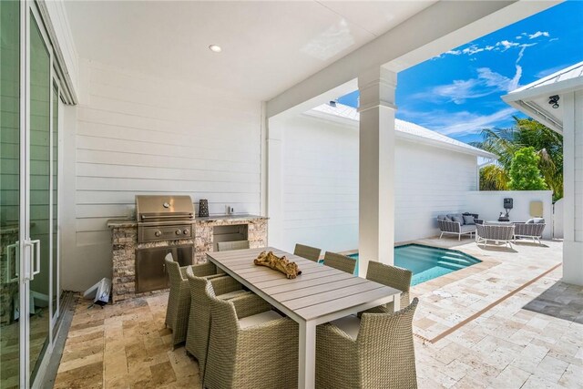 30 Strand Dr, Vero Beach, FL 32963 - view of patio with outdoor dining space, exterior kitchen, and an outdoor pool