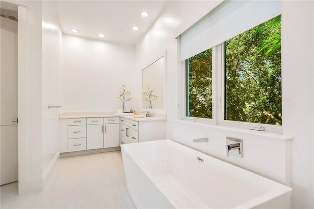 30 Strand Dr, Vero Beach, FL 32963 - full bath with a freestanding bath, vanity, recessed lighting, and tile patterned floors