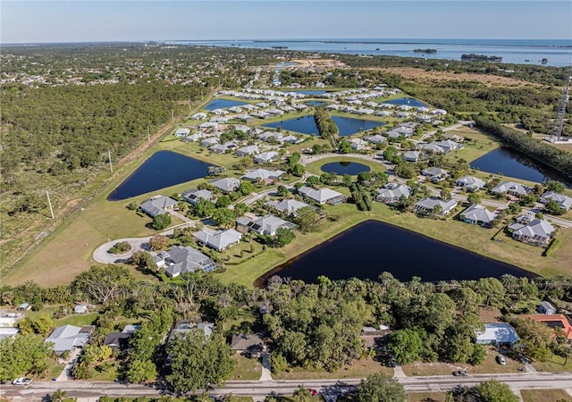 drone / aerial view featuring a residential view and a water view