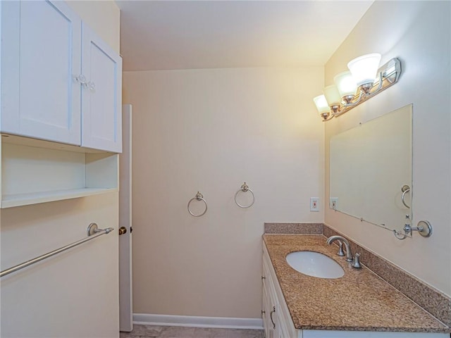 bathroom with baseboards and vanity