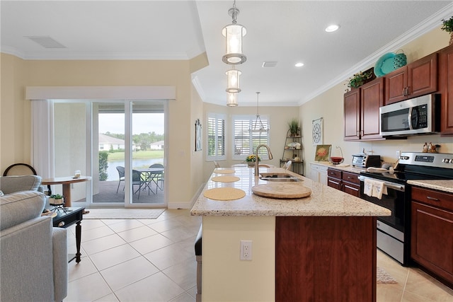 kitchen featuring appliances with stainless steel finishes, ornamental molding, sink, decorative light fixtures, and an island with sink