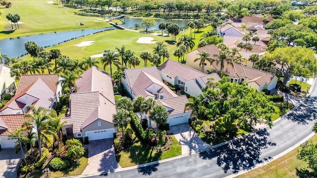 birds eye view of property featuring view of golf course, a water view, and a residential view