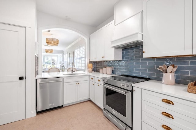 kitchen with premium range hood, a sink, tasteful backsplash, appliances with stainless steel finishes, and light countertops