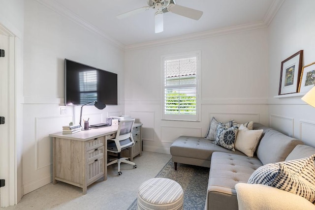 office with a decorative wall, ceiling fan, and ornamental molding