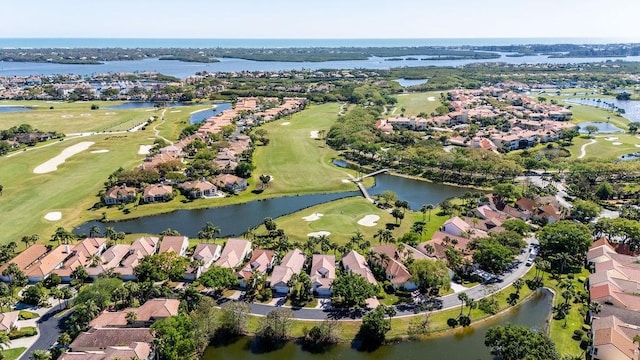 drone / aerial view featuring a residential view, a water view, and view of golf course