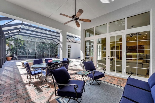 view of patio / terrace with a lanai, ceiling fan, and french doors