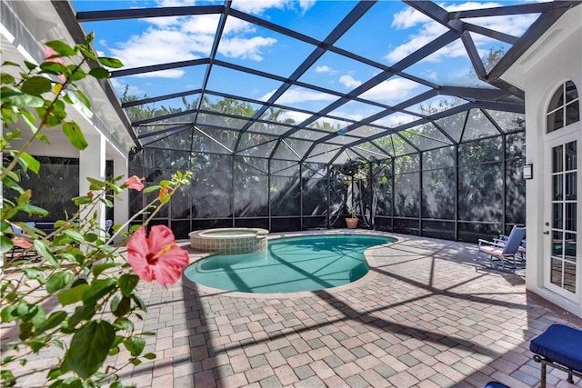 view of swimming pool featuring an in ground hot tub, a lanai, and a patio area