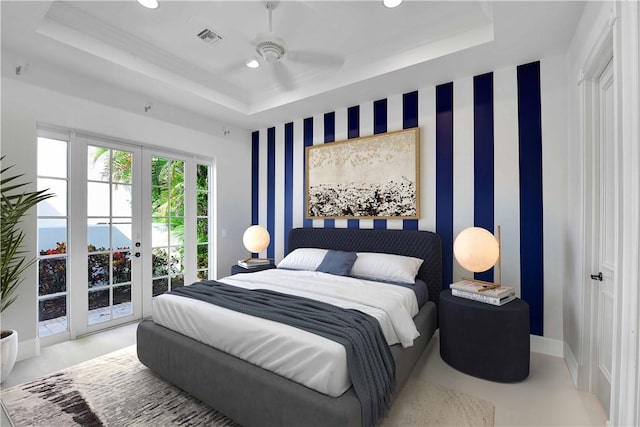 bedroom featuring french doors, ceiling fan, a tray ceiling, and access to exterior