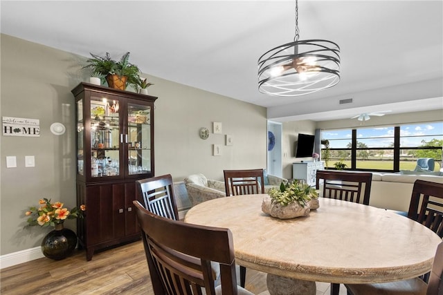 31 Plantation Dr Unit 205, Vero Beach, FL 32966 - dining area with a chandelier, light wood-style floors, and a ceiling fan
