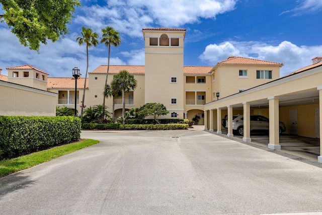 view of building exterior featuring covered parking
