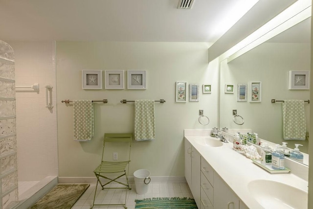 full bathroom with visible vents, a sink, tile patterned flooring, and tiled shower