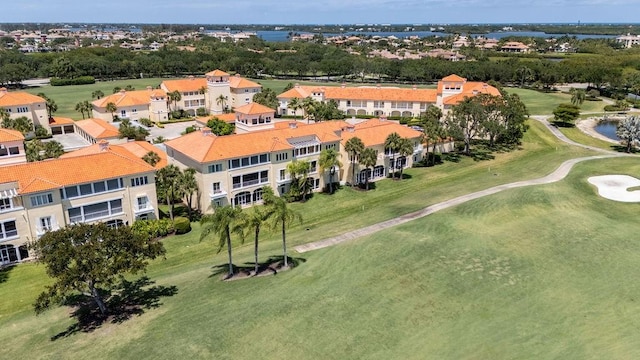 drone / aerial view featuring view of golf course and a water view