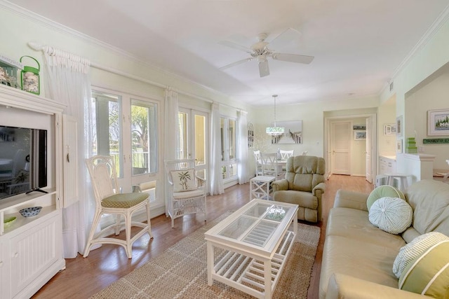 living area featuring ornamental molding, light wood finished floors, and ceiling fan