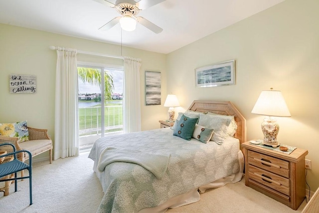 carpeted bedroom featuring access to outside and a ceiling fan