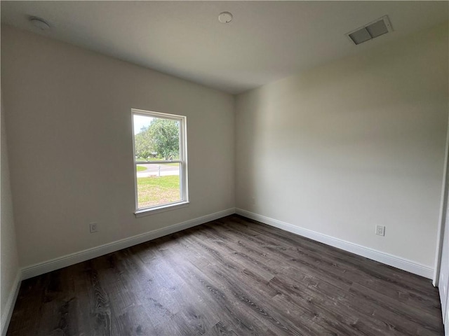 unfurnished room with dark hardwood / wood-style floors