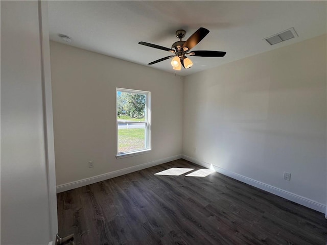 empty room featuring ceiling fan and dark hardwood / wood-style floors