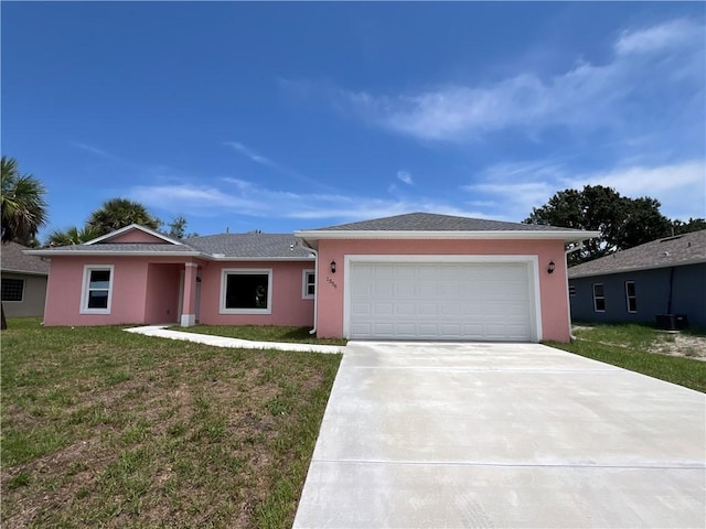 single story home with a front lawn and a garage