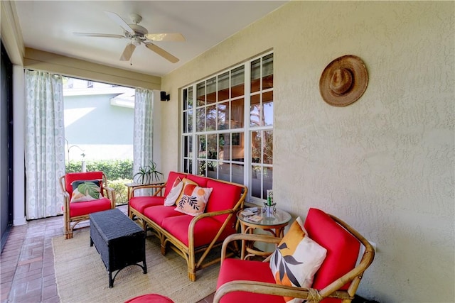 sunroom / solarium featuring ceiling fan