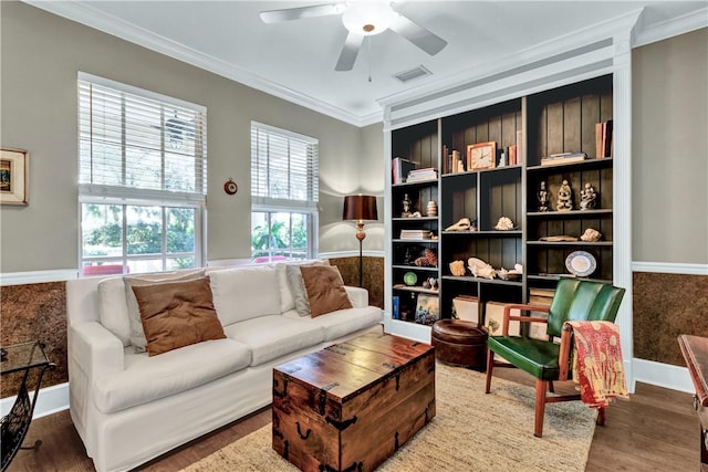 living area featuring ceiling fan, dark hardwood / wood-style flooring, and crown molding