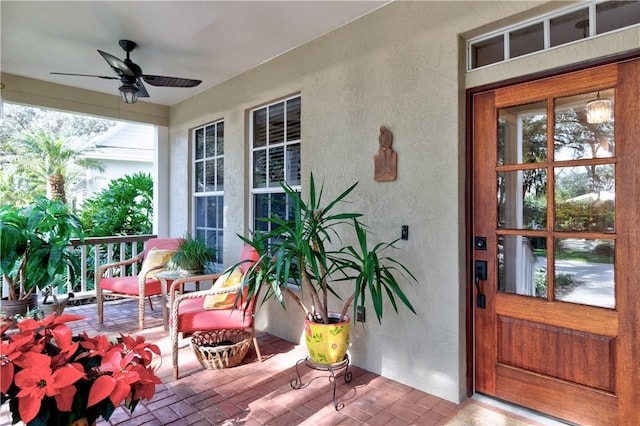 entrance to property featuring ceiling fan and covered porch