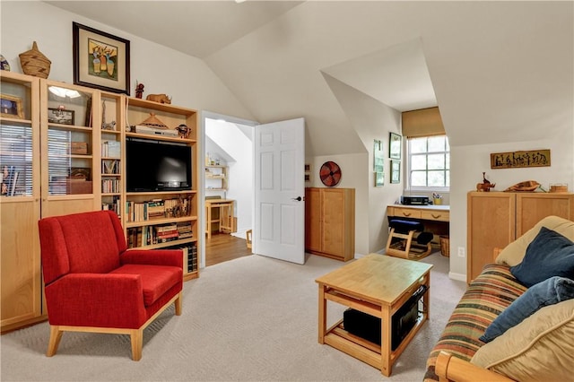 living room featuring light colored carpet and vaulted ceiling