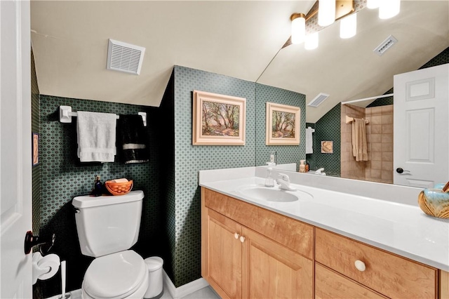 bathroom with vanity, toilet, and vaulted ceiling