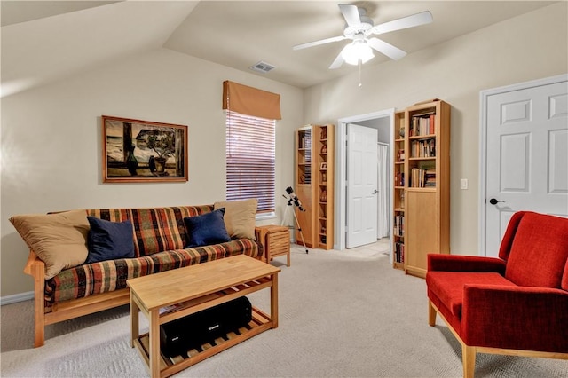 living room featuring light colored carpet, vaulted ceiling, and ceiling fan