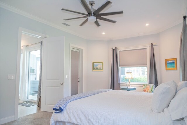 carpeted bedroom featuring ceiling fan and crown molding