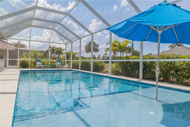 view of pool with a patio and a lanai