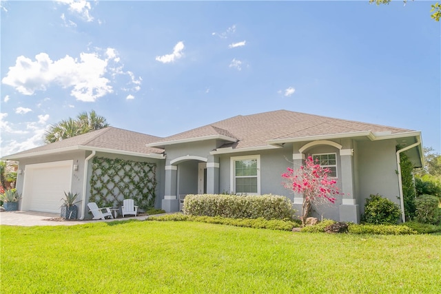 view of front of property featuring a garage and a front lawn