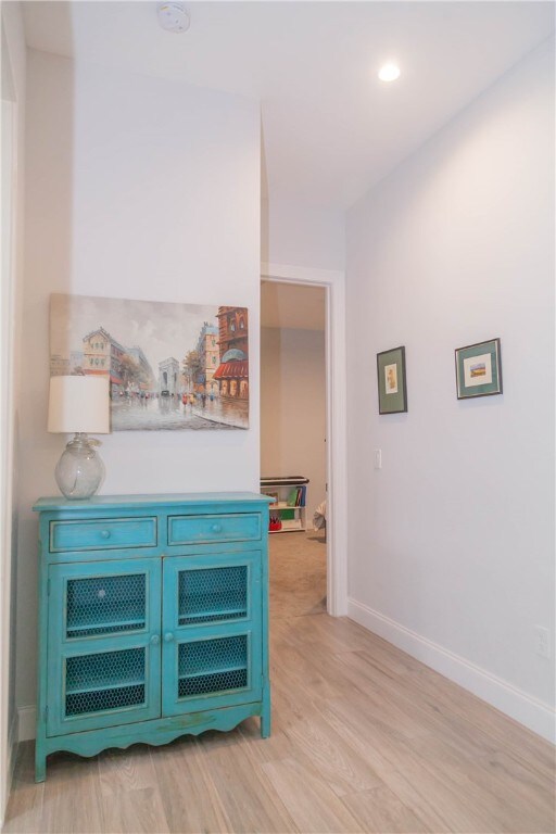 interior space with blue cabinets and light hardwood / wood-style flooring