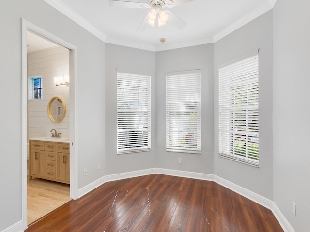 unfurnished room with dark wood-type flooring, ceiling fan, sink, and ornamental molding