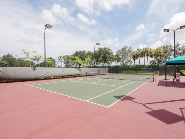 view of tennis court with basketball hoop