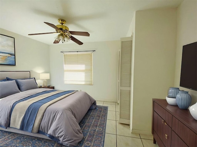 tiled bedroom featuring ceiling fan