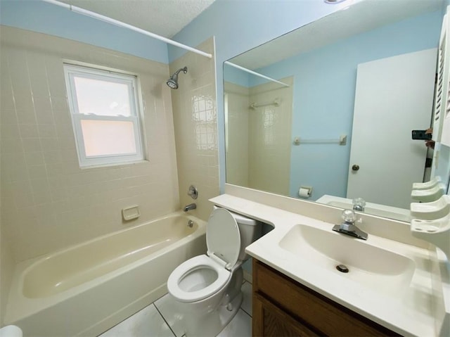 full bathroom with vanity, tiled shower / bath, tile patterned flooring, toilet, and a textured ceiling