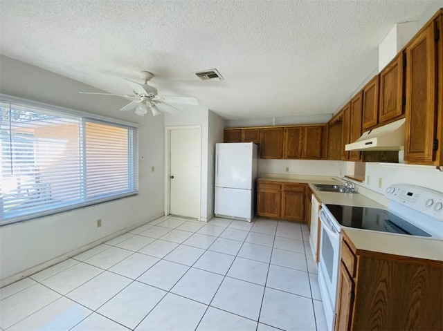 kitchen featuring a textured ceiling, ceiling fan, sink, and white appliances