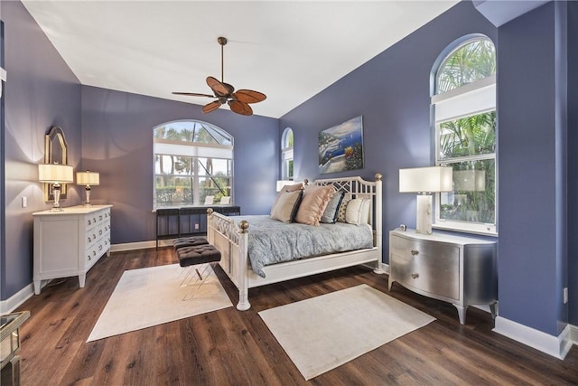 bedroom featuring multiple windows, dark hardwood / wood-style floors, and ceiling fan