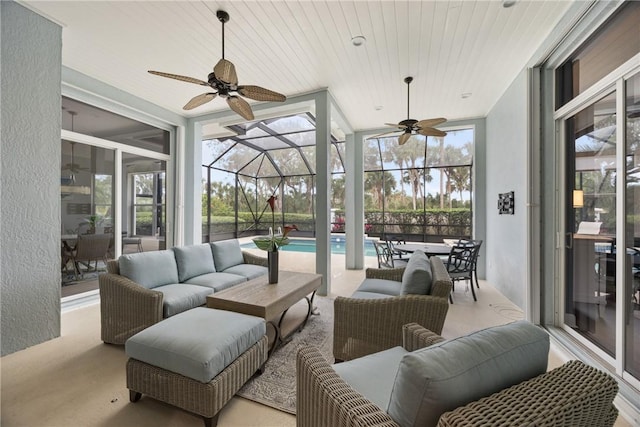 sunroom / solarium featuring ceiling fan, a swimming pool, and plenty of natural light