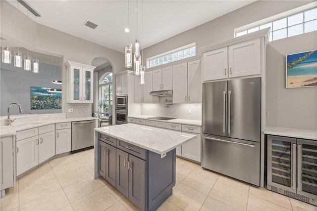 kitchen featuring white cabinetry, sink, beverage cooler, and appliances with stainless steel finishes