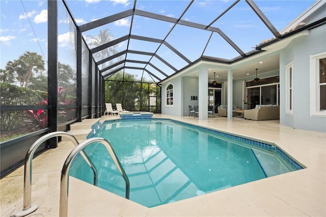 view of pool with a lanai, a patio area, ceiling fan, and an in ground hot tub