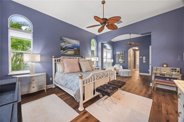 bedroom featuring multiple windows, ceiling fan, and dark hardwood / wood-style floors