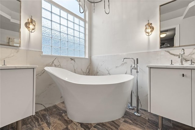 bathroom featuring vanity, a bathtub, and tile walls