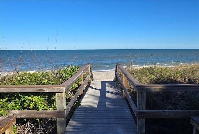 view of home's community with a water view and a view of the beach