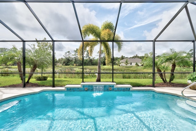 view of pool with a lanai, pool water feature, and a jacuzzi