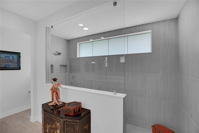 bathroom with tiled shower