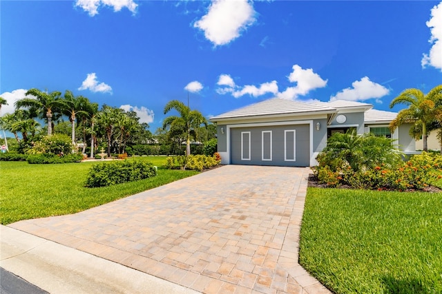 view of front of property featuring a garage and a front lawn