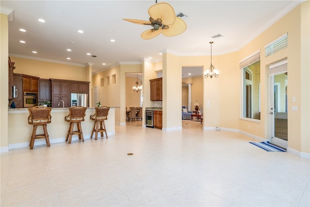 interior space featuring wine cooler, appliances with stainless steel finishes, a breakfast bar, and crown molding