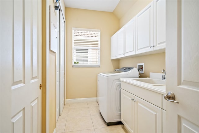 laundry room featuring sink, cabinets, washing machine and clothes dryer, and light tile patterned floors