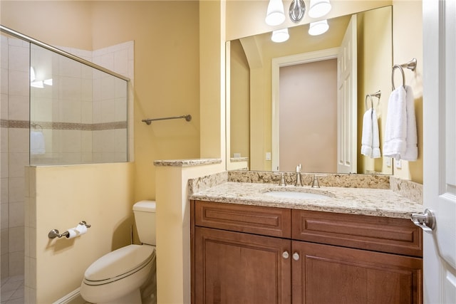 bathroom featuring vanity, toilet, and tiled shower